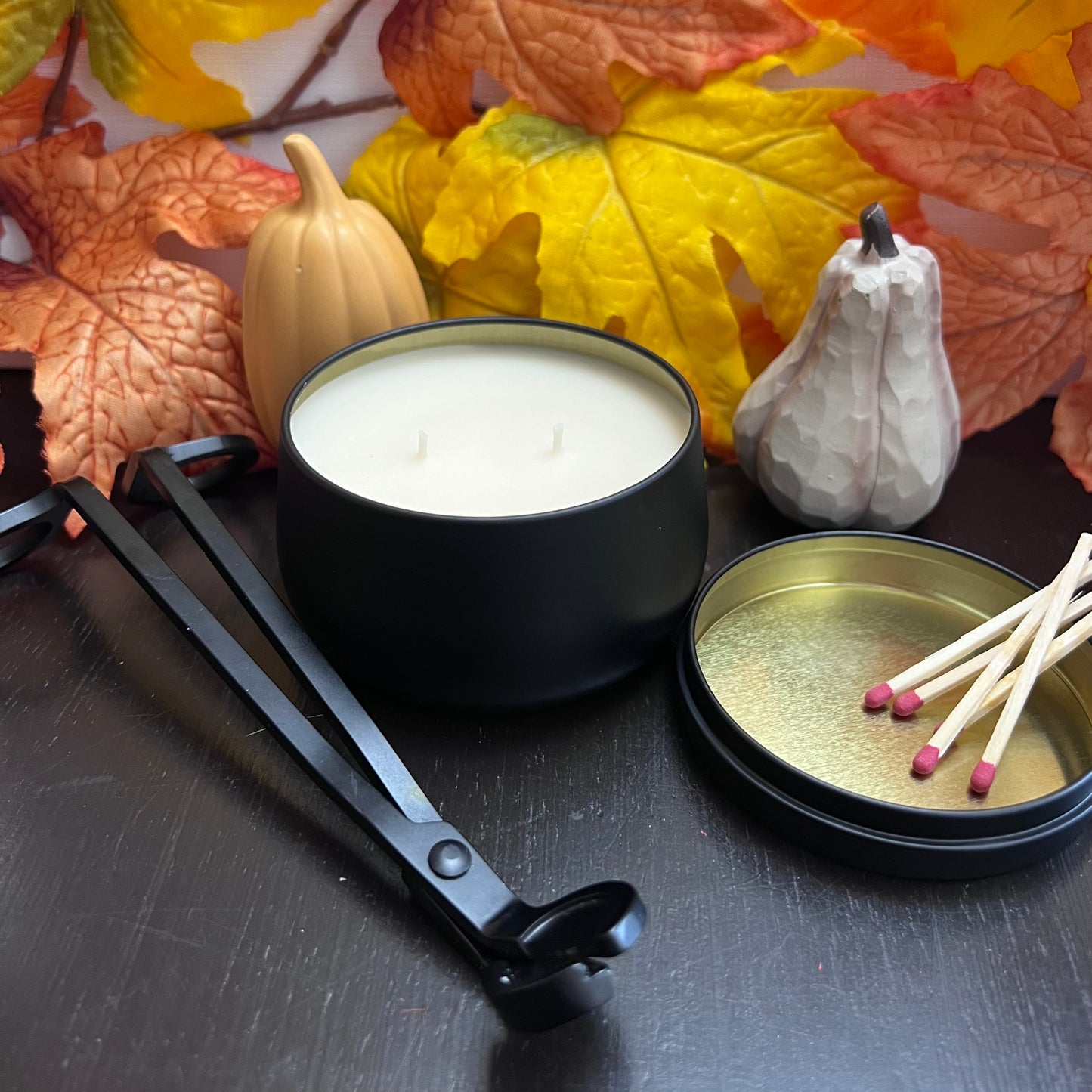Black candle, round. Wick trimmers, mathes in candle lid, fall themed decor.