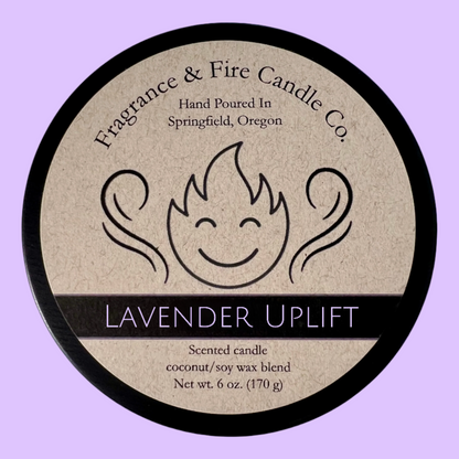 Light purple colored background with round candle top and brown label. Name of the candle on the label is Lavender Uplift.