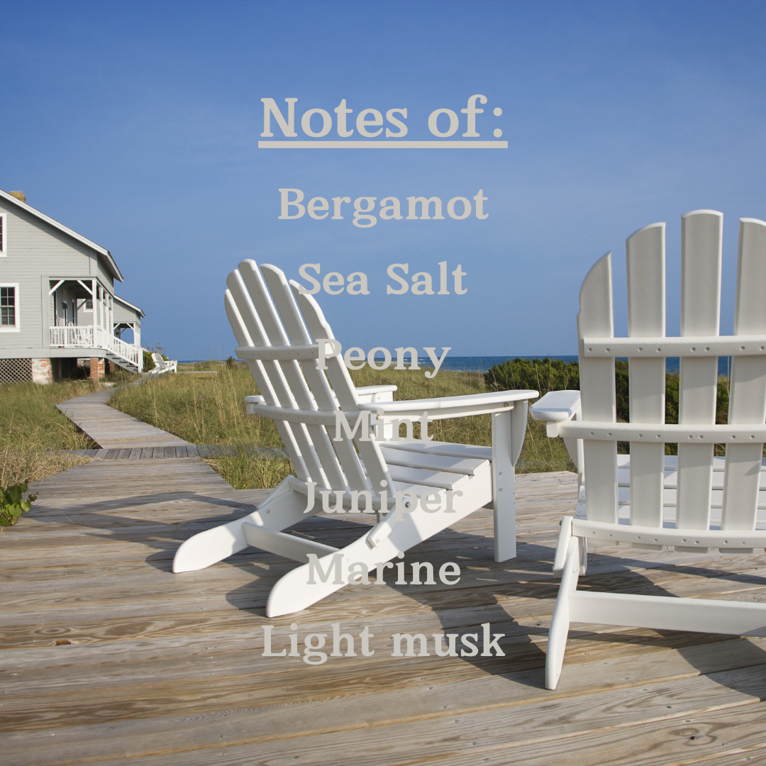 The candles scent notes are listed as Bergamot, sea salt, peony, mint, juniper, marine, and light musk. The background is two white beach chairs on a wood deck coming from a house on grass looking towards the ocean.