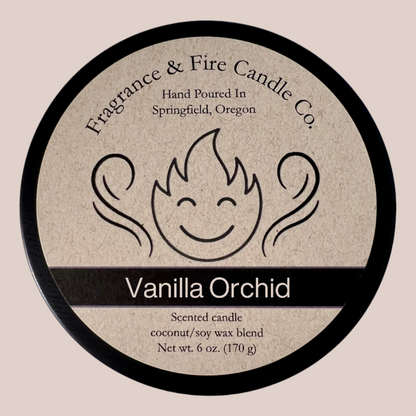 Light tan colored background with round candle top and brown label. Name of the candle on the label is Vanilla Orchid.